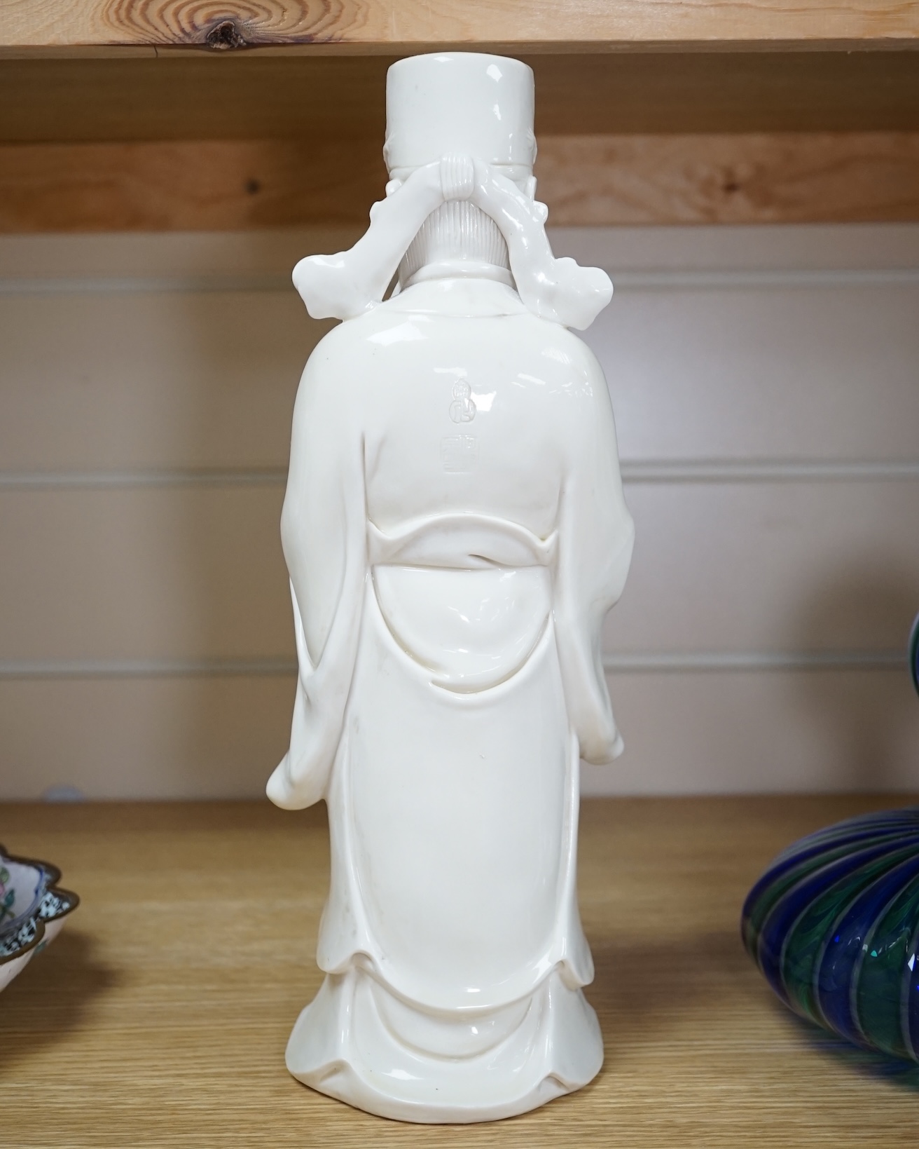 A Chinese blanc de chine Buddha figure, stamped to the reverse, 30cm high. Condition - Good